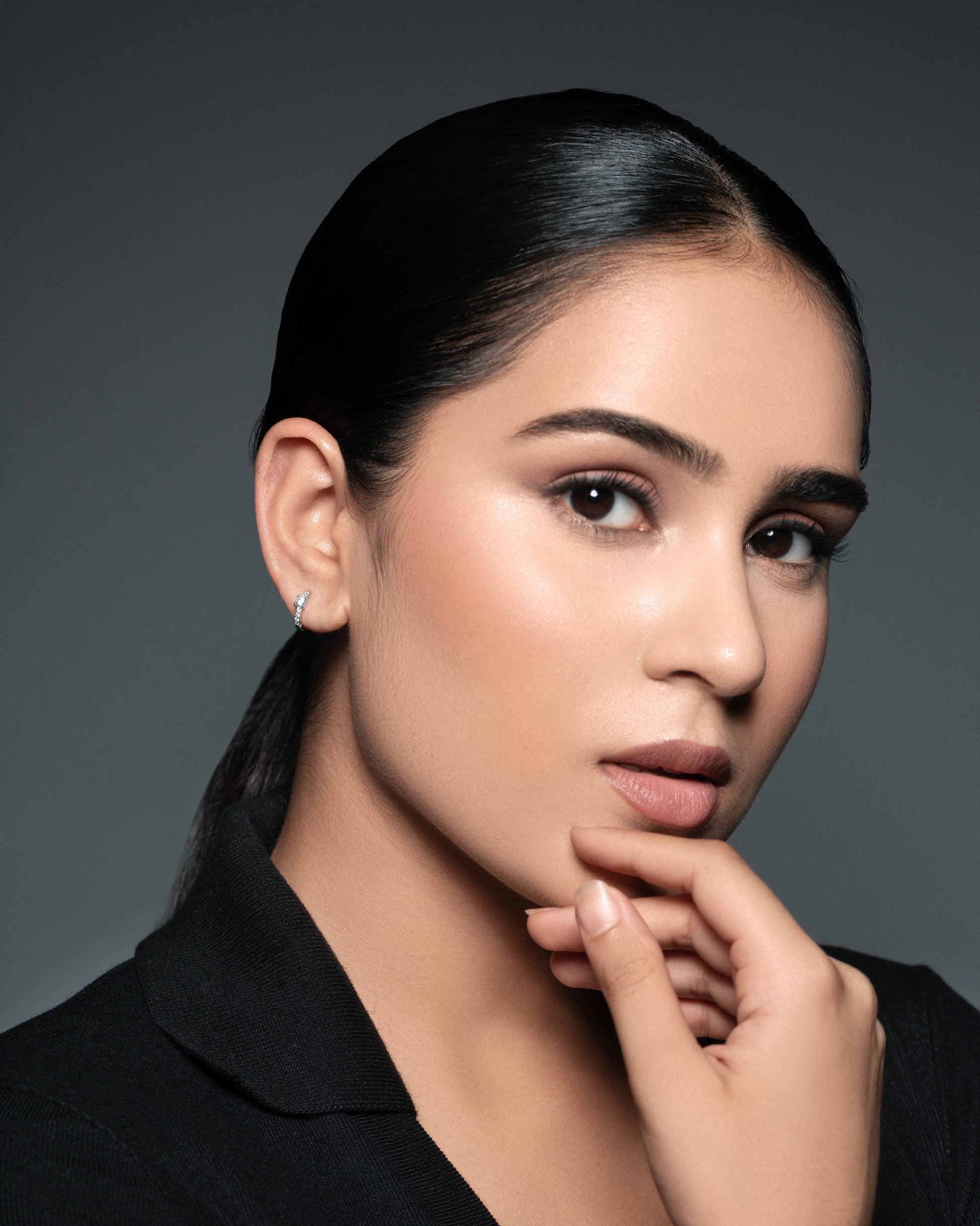 Model wearing Solitaire Zirconia Hoop earrings in 92.5 silver, highlighting their elegant and minimalistic design for everyday wear.