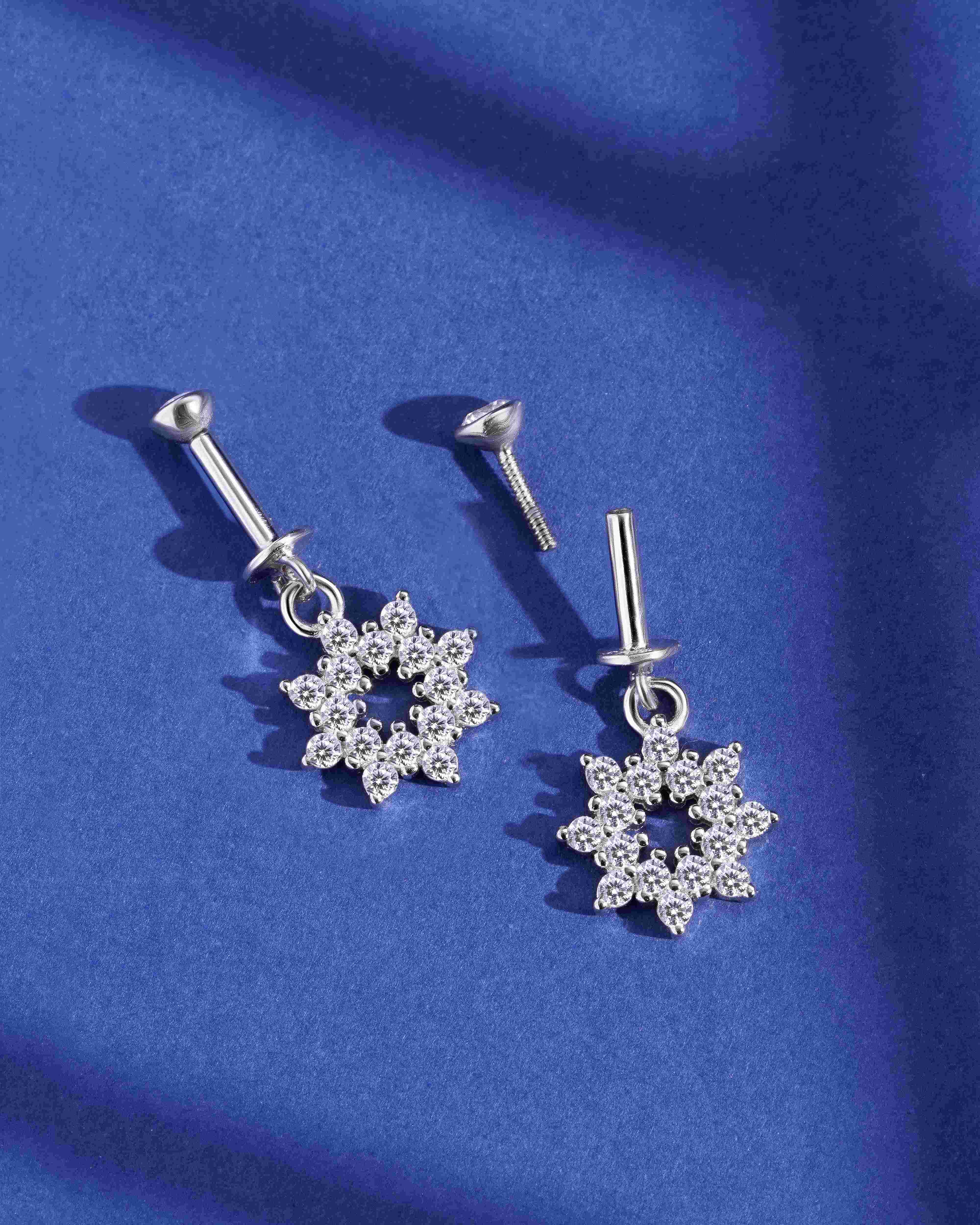 Helix Hanging Earrings - Zircon Bubble Burst in a floral starburst design, crafted in pure silver with shimmering zircon stones on a blue background.
