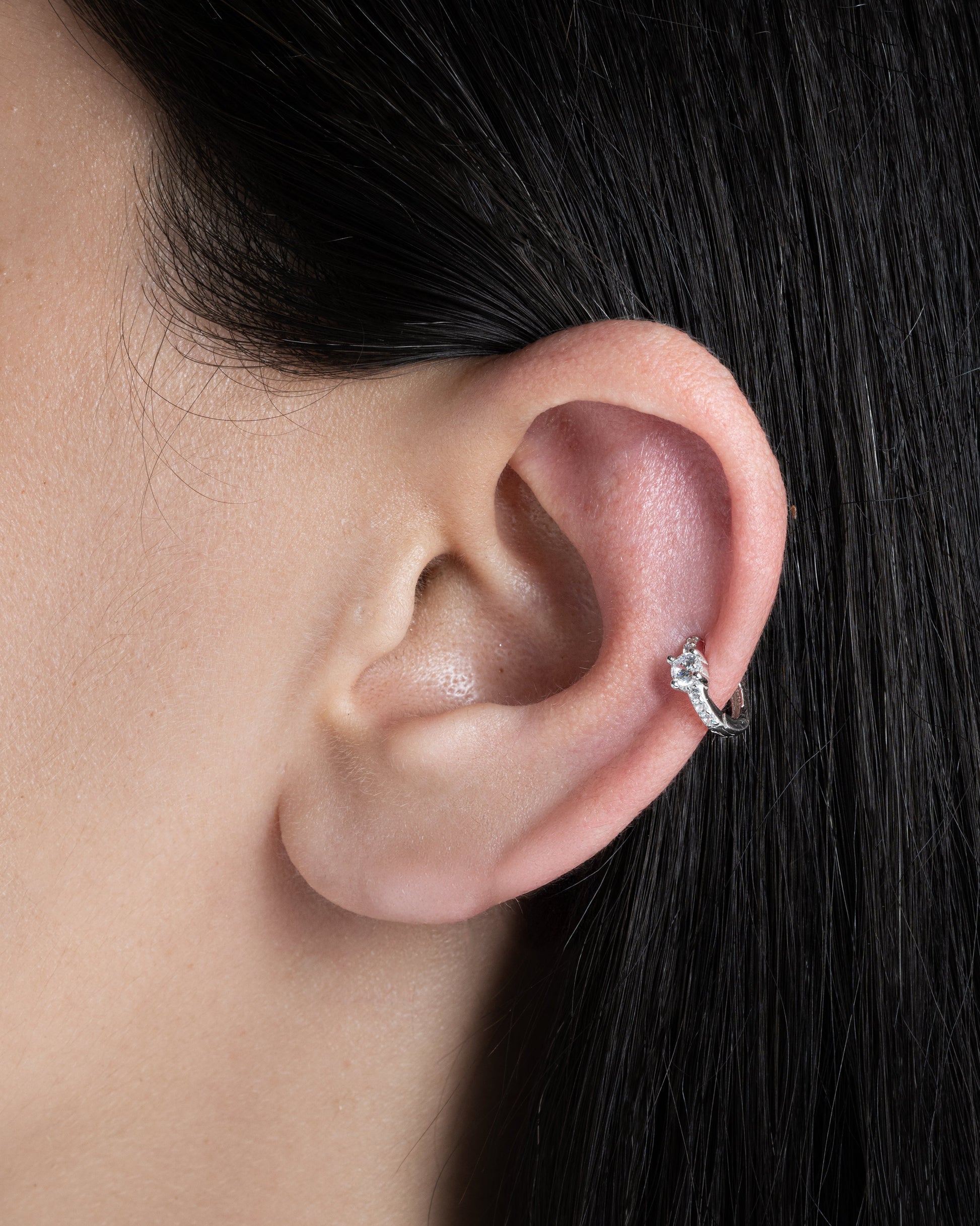 Close-up of Solitaire Zirconia Hoop earring in 92.5 silver worn on the ear, showcasing its intricate zirconia stone detailing.
