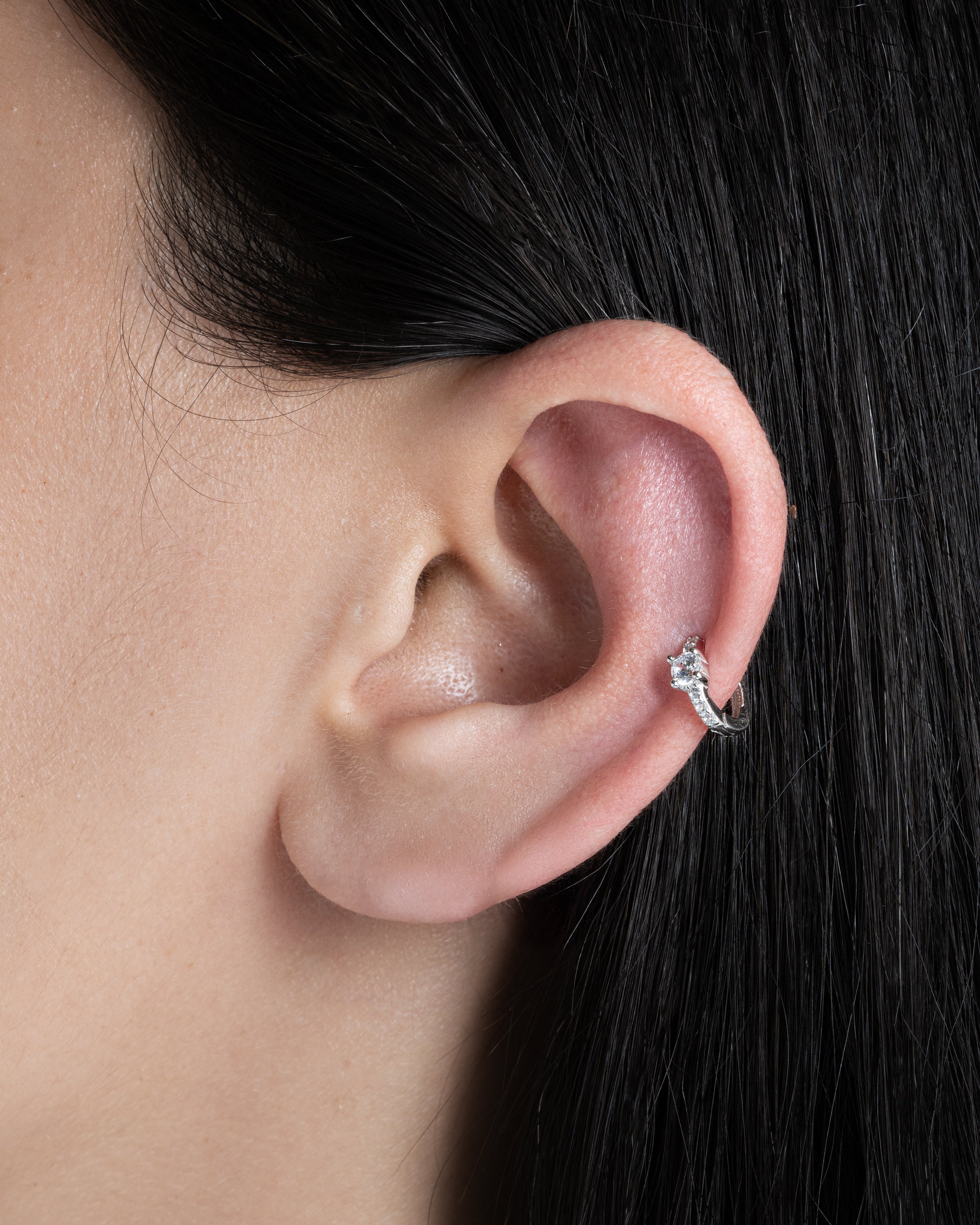 Close-up of Solitaire Zirconia Hoop earring in 92.5 silver worn on the ear, showcasing its intricate zirconia stone detailing.