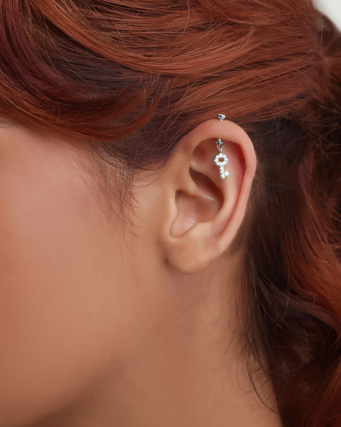 Helix Piercing Hanging earrings featuring mismatched zircon lock and key design in sterling silver. Unique jewelry style for cartilage piercings.