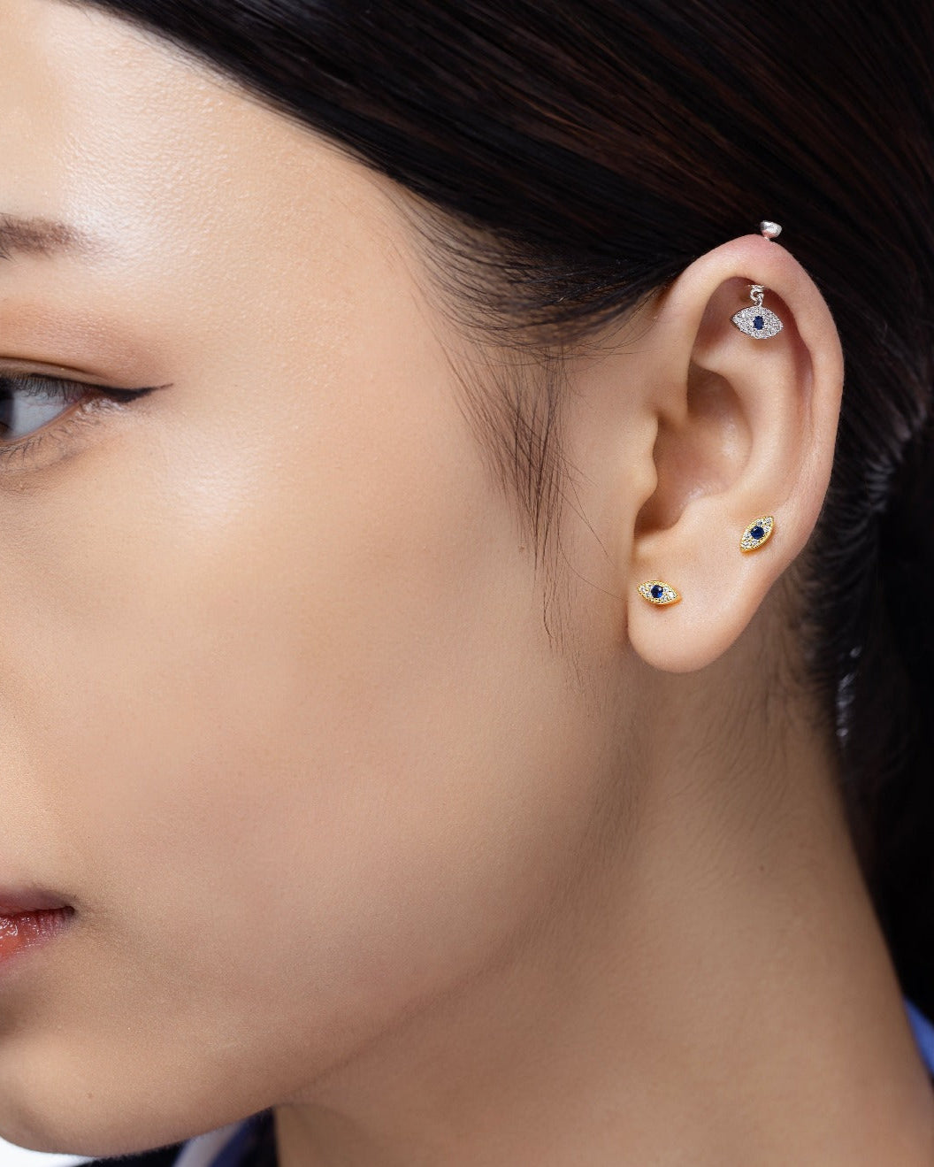 Zirconia Small Evil Eye Earrings - Versatile Style | Hanging Pair in sterling silver with blue center stones and pavé zirconia, shown on white background.